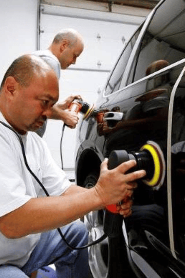 Roland A. Nalagan polishing a black Porsche 911 at Auto Perfection Services in St. Louis